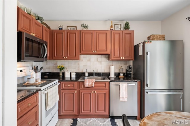 621 Sugar Trail Ct Unit 4, Saint Peters, MO 63376 - kitchen with appliances with stainless steel finishes, a sink, tasteful backsplash, and brown cabinets