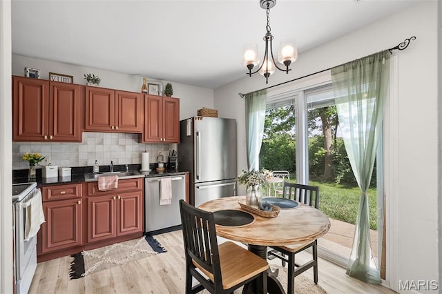 621 Sugar Trail Ct Unit 4, Saint Peters, MO 63376 - kitchen with stainless steel appliances, dark countertops, decorative backsplash, and light wood-style floors