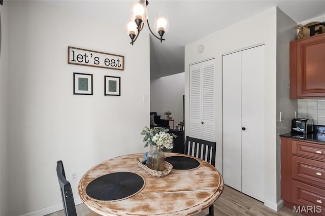 621 Sugar Trail Ct Unit 4, Saint Peters, MO 63376 - dining area with light wood-style floors, baseboards, and a chandelier