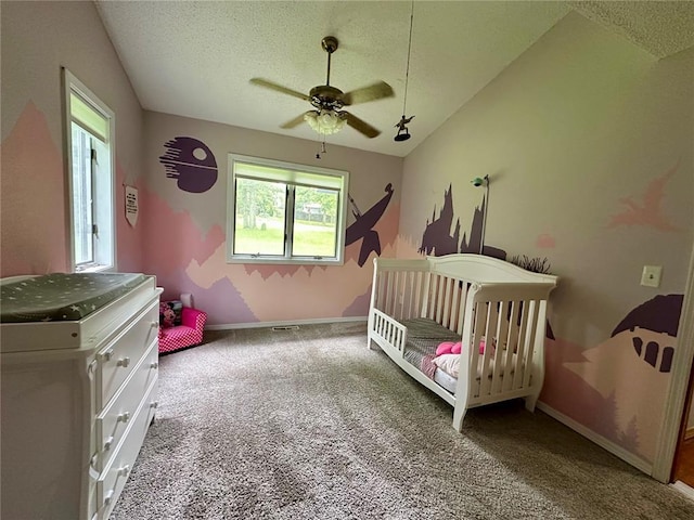 12185 Oak Meadow Dr, Rolla, MO 65401 - carpeted bedroom with a textured ceiling, baseboards, a nursery area, and ceiling fan