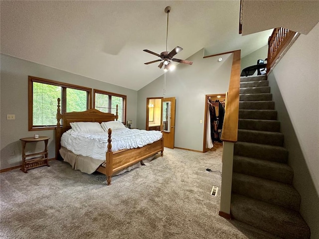 12185 Oak Meadow Dr, Rolla, MO 65401 - bedroom featuring carpet flooring, a walk in closet, baseboards, high vaulted ceiling, and a ceiling fan