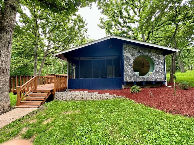 12185 Oak Meadow Dr, Rolla, MO 65401 - view of front of property with a sunroom, stone siding, a front lawn, and a deck