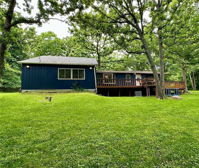 12185 Oak Meadow Dr, Rolla, MO 65401 - rear view of house with a deck, board and batten siding, a yard, and central air condition unit