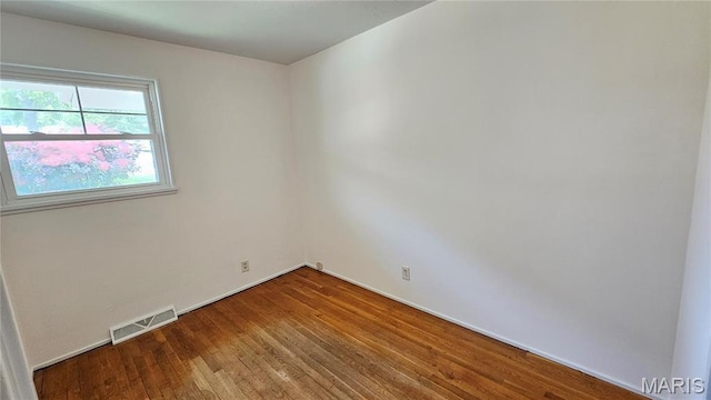 9117 Tiber Ct, Affton, MO 63123 - unfurnished room with wood finished floors and baseboards