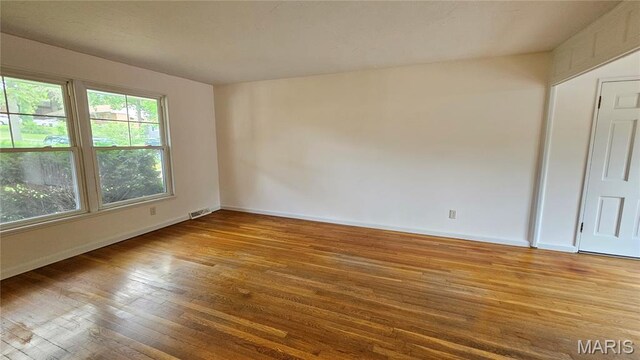 9117 Tiber Ct, Affton, MO 63123 - spare room with wood-type flooring and baseboards