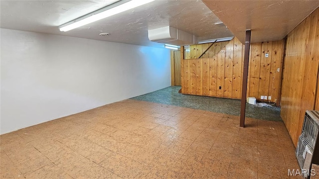 9117 Tiber Ct, Affton, MO 63123 - finished basement featuring tile patterned floors, wood walls, and heating unit