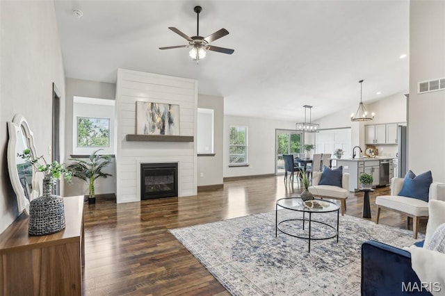 520 W 5th St, Saint Jacob, IL 62281 - living room with plenty of natural light, vaulted ceiling, dark wood-type flooring, ceiling fan, and a chandelier