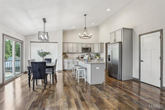 520 W 5th St, Saint Jacob, IL 62281 - kitchen with stainless steel appliances, gray cabinetry, a chandelier, a center island with sink, and dark wood-style flooring
