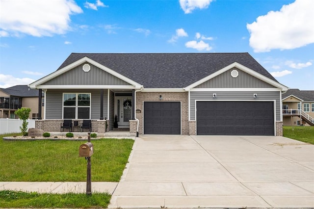 1448 Guilford Pl, Troy, IL 62294 - view of front of property with a garage, brick siding, driveway, a porch, and a front lawn