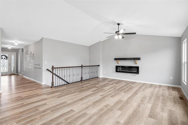 1448 Guilford Pl, Troy, IL 62294 - unfurnished living room featuring ceiling fan, light wood-type flooring, baseboards, a glass covered fireplace, and lofted ceiling