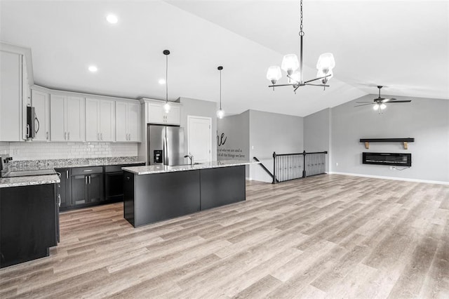 1448 Guilford Pl, Troy, IL 62294 - kitchen with stainless steel appliances, vaulted ceiling, tasteful backsplash, ceiling fan, and a center island with sink