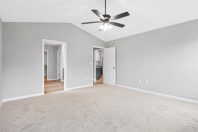 1448 Guilford Pl, Troy, IL 62294 - unfurnished bedroom featuring light colored carpet, baseboards, vaulted ceiling, and ceiling fan