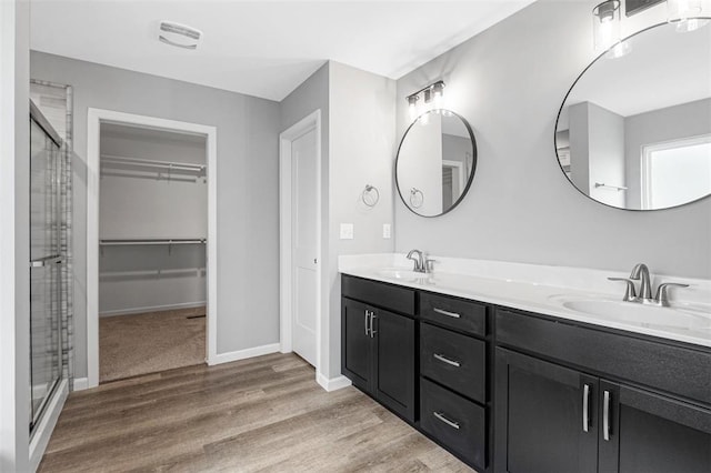 1448 Guilford Pl, Troy, IL 62294 - full bathroom with double vanity, a shower stall, wood finished floors, and a spacious closet