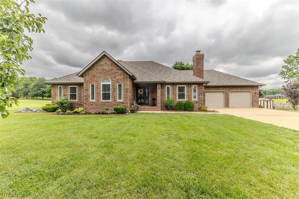 26670 Old Fern Ln, Lebanon, MO 65536 - ranch-style home with brick siding, a chimney, a shingled roof, and an attached garage