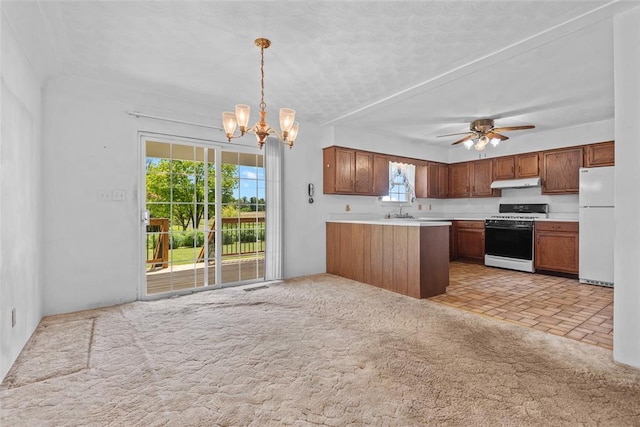 8800 Country Ln, Troy, IL 62294 - kitchen with white appliances, under cabinet range hood, a chandelier, light countertops, and pendant lighting