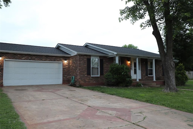 601 Edward St, Farmington, MO 63640 - ranch-style house featuring brick siding, a porch, a front lawn, driveway, and an attached garage