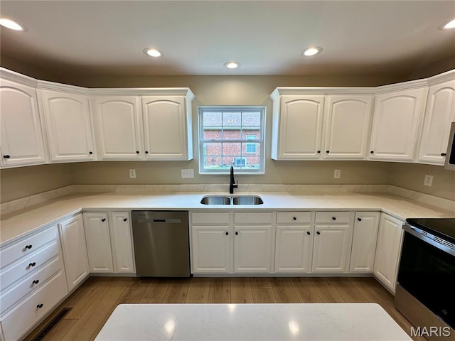 1724 Shadow Rdg, Columbia, IL 62236 - kitchen with appliances with stainless steel finishes, a sink, wood finished floors, white cabinets, and recessed lighting