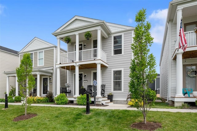 369 Tiber Pl, Saint Charles, MO 63301 - greek revival house featuring a balcony, a porch, and a front yard