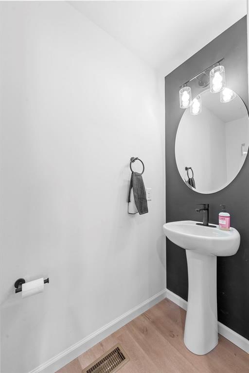 369 Tiber Pl, Saint Charles, MO 63301 - bathroom with wood finished floors, baseboards, and a sink