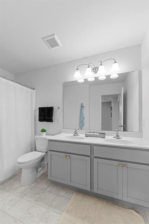 369 Tiber Pl, Saint Charles, MO 63301 - full bath featuring double vanity, toilet, and tile patterned floors