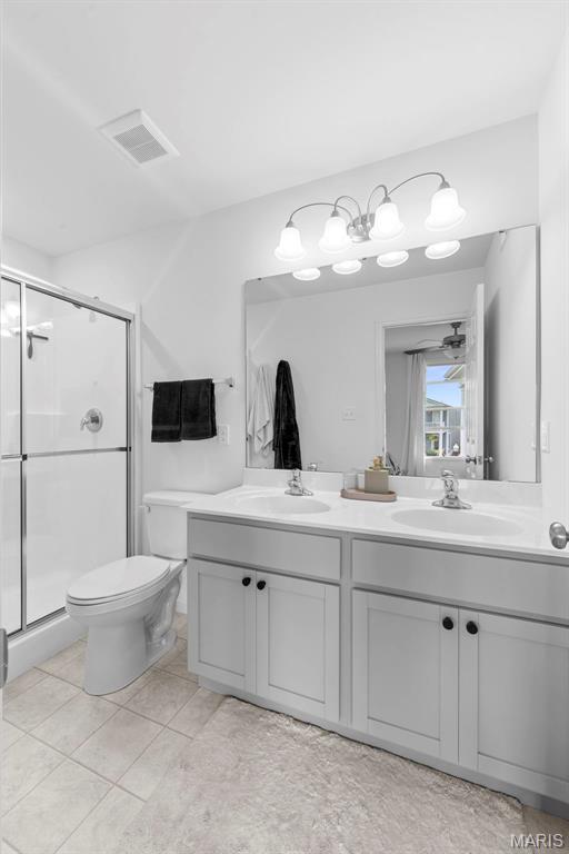 369 Tiber Pl, Saint Charles, MO 63301 - bathroom with double vanity, a stall shower, toilet, and tile patterned flooring