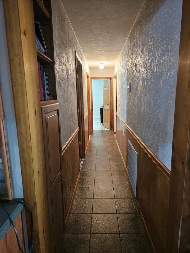 202 Jeremiah, Willisville, IL 62997 - hall featuring a textured ceiling, wainscoting, and wood walls