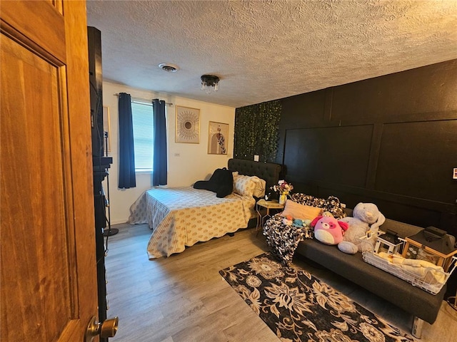 202 Jeremiah, Willisville, IL 62997 - bedroom featuring wood finished floors and a textured ceiling
