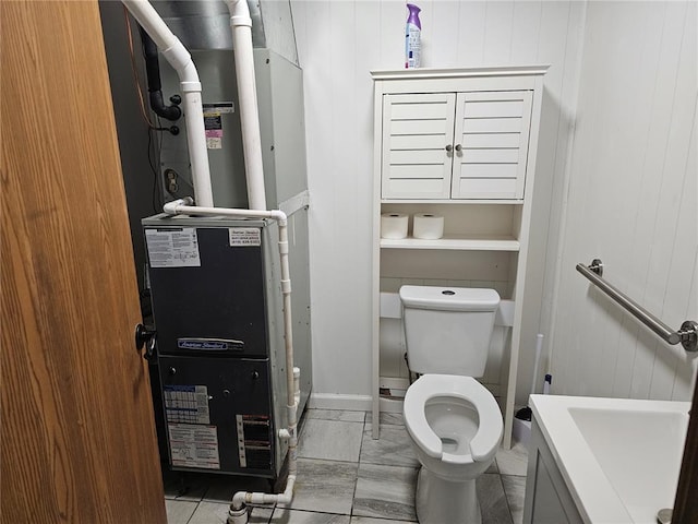 202 Jeremiah, Willisville, IL 62997 - bathroom featuring toilet, heating unit, and wood walls