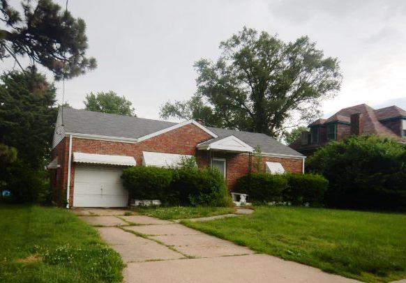1917 Mclaran Ave, Jennings, MO 63136 - view of front of house featuring brick siding, a front yard, concrete driveway, and an attached garage