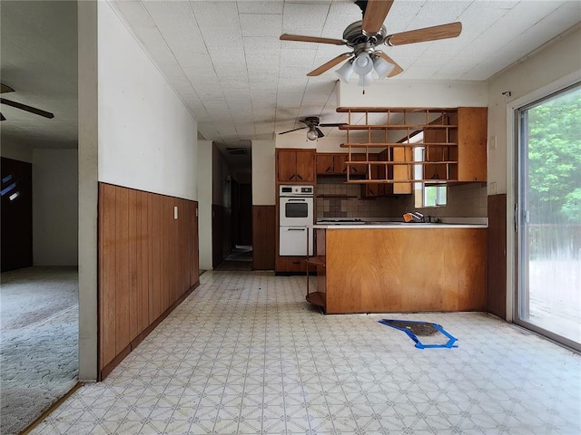 1505 Dale St, Van Buren, MO 63965 - kitchen featuring a ceiling fan, light floors, open shelves, white double oven, and a peninsula