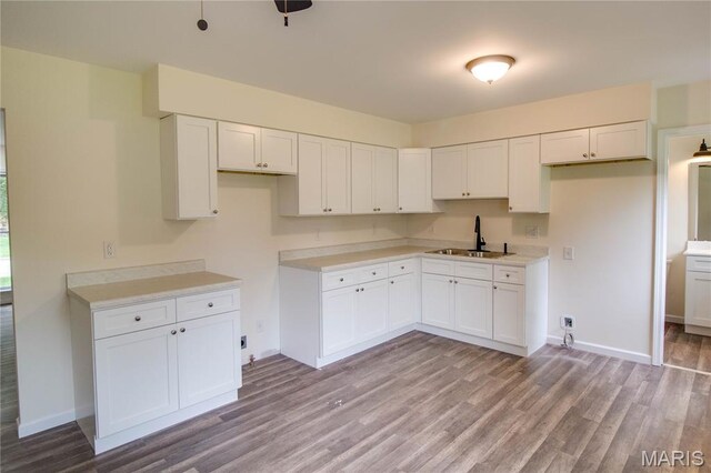 615 Saint Peter Dr, Godfrey, IL 62035 - kitchen featuring a sink, light wood-style flooring, baseboards, white cabinets, and light countertops