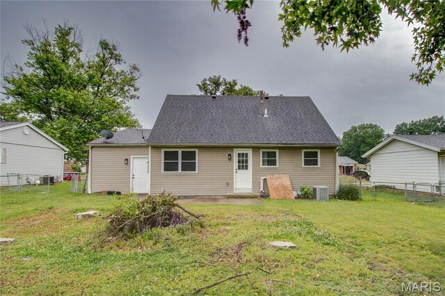615 Saint Peter Dr, Godfrey, IL 62035 - rear view of property with central air condition unit and roof with shingles