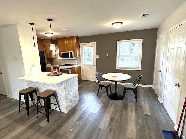 436 S 5th St, Caseyville, IL 62232 - kitchen featuring white appliances, brown cabinetry, dark wood finished floors, light countertops, and baseboards