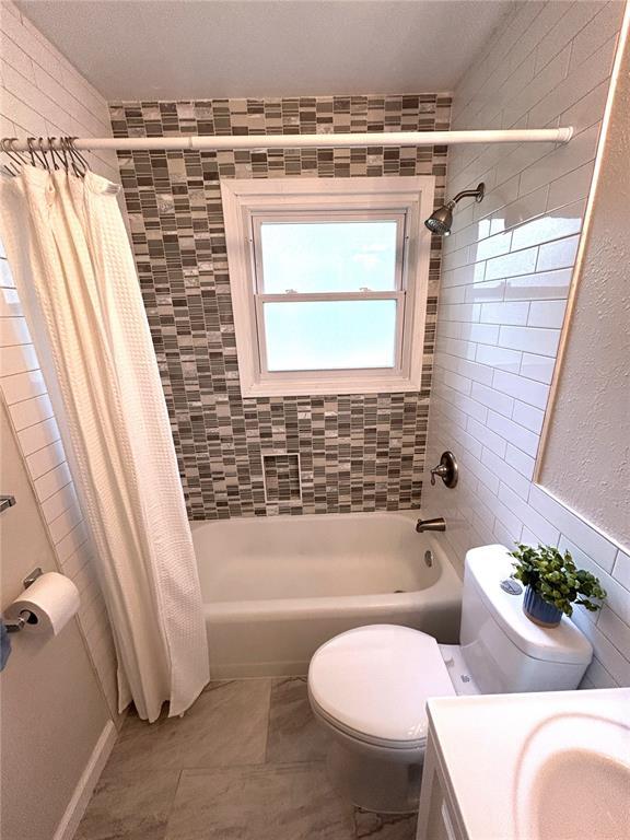 436 S 5th St, Caseyville, IL 62232 - bathroom featuring vanity, shower / bath combo with shower curtain, and toilet