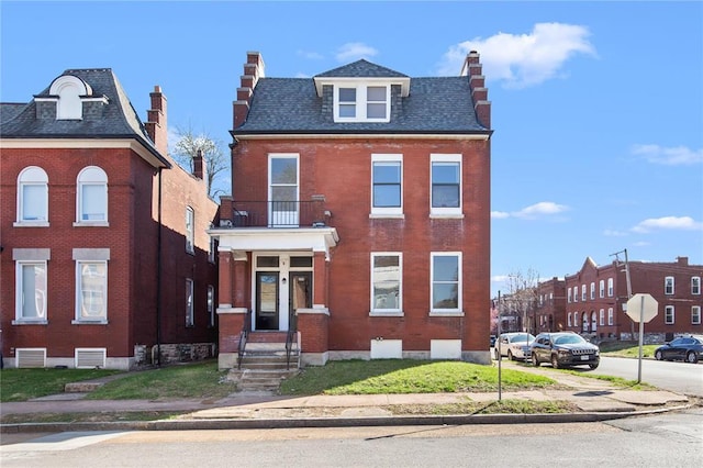 2856 Wyoming St, Saint Louis, MO 63118 - view of front of property featuring brick siding, a balcony, and a chimney