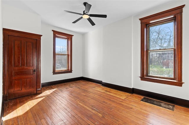2856 Wyoming St, Saint Louis, MO 63118 - unfurnished room featuring hardwood / wood-style flooring, baseboards, and a ceiling fan