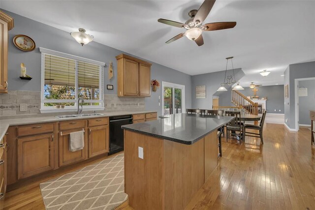1002 Brook Mont Dr, Ofallon, MO 63366 - kitchen with a sink, black dishwasher, a ceiling fan, and tasteful backsplash