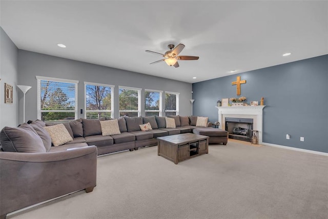 1002 Brook Mont Dr, Ofallon, MO 63366 - living area with light carpet, a fireplace with flush hearth, a ceiling fan, recessed lighting, and baseboards