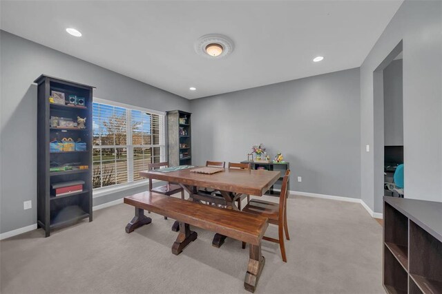1002 Brook Mont Dr, Ofallon, MO 63366 - dining area with light colored carpet, baseboards, and recessed lighting