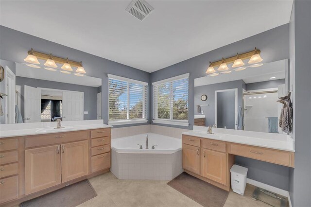 1002 Brook Mont Dr, Ofallon, MO 63366 - bathroom with two vanities, a garden tub, and a stall shower
