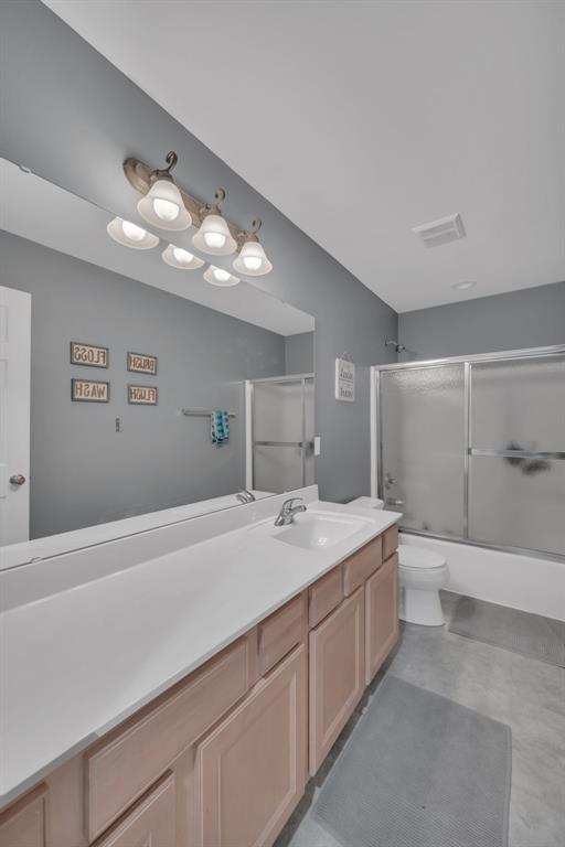1002 Brook Mont Dr, Ofallon, MO 63366 - full bath with vanity, enclosed tub / shower combo, and toilet