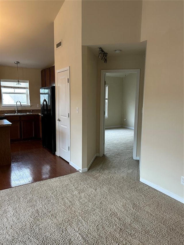 333 Bramblett Hls, Ofallon, MO 63366 - kitchen with freestanding refrigerator, dark carpet, a sink, baseboards, and decorative light fixtures