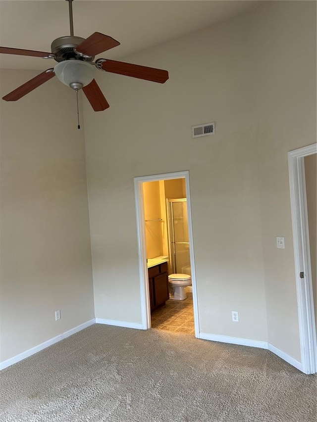 333 Bramblett Hls, Ofallon, MO 63366 - unfurnished bedroom featuring a towering ceiling, light carpet, baseboards, ensuite bath, and a ceiling fan