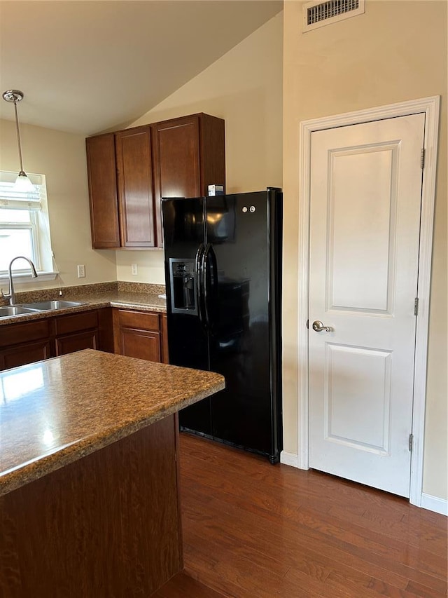 333 Bramblett Hls, Ofallon, MO 63366 - kitchen with black fridge, a sink, vaulted ceiling, dark wood-type flooring, and pendant lighting