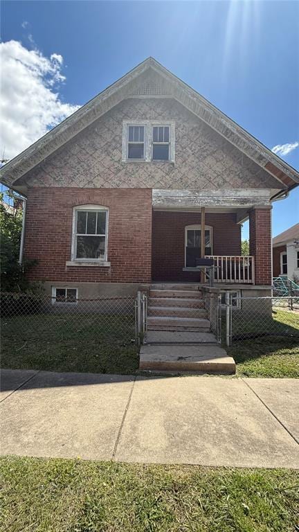 114 N W End Blvd, Cape Girardeau, MO 63701 - view of front of home featuring covered porch, a fenced front yard, and brick siding