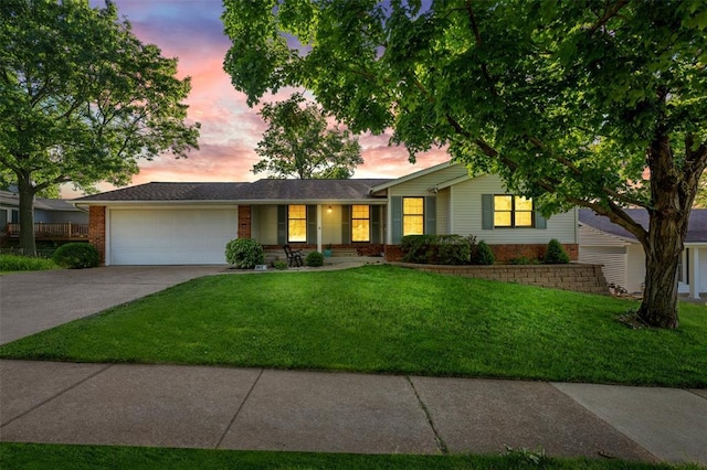 5812 Birch Hollow Dr, Oakville, MO 63129 - ranch-style home featuring a garage, brick siding, concrete driveway, and a front lawn