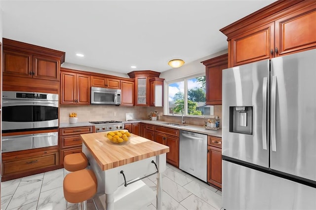 5812 Birch Hollow Dr, Oakville, MO 63129 - kitchen with appliances with stainless steel finishes, a warming drawer, light marble finish flooring, butcher block counters, and a sink