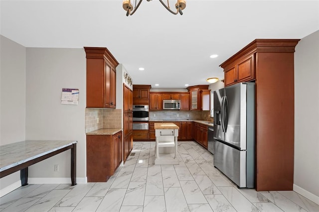 5812 Birch Hollow Dr, Oakville, MO 63129 - kitchen featuring stainless steel appliances, light marble finish floors, baseboards, and recessed lighting