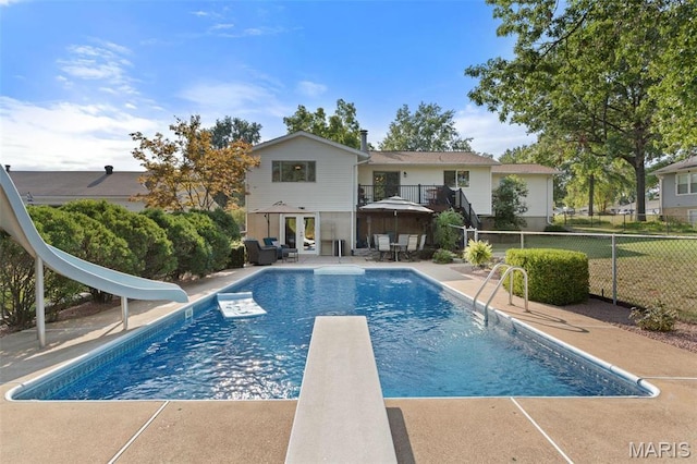 5812 Birch Hollow Dr, Oakville, MO 63129 - view of swimming pool with a water slide, a diving board, french doors, and a patio