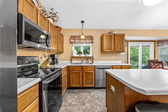30 Fawn View Ln, Ofallon, MO 63366 - kitchen featuring appliances with stainless steel finishes, a sink, plenty of natural light, and brown cabinets